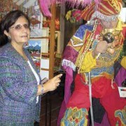 Museum director Marilda García points out details and facts during her tour of the art works