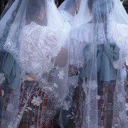 Hundreds of women line the streets and participate in their colorful shawls; young women, little girls, and grandmothers wear the white lacy veils that mark their devotion. (photo: Victoria Stone)