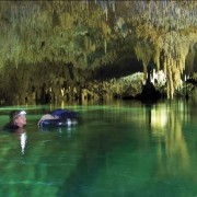 Janson uses an inner tube to keep his equipment dry as he explores a water-filled cavern