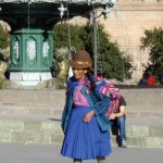 Woman wears colorful Peruvian crafts in Cuzco