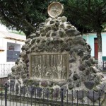 Monument on Ciudad Vieja church plaza depicts founding “here on this site the city of Santiago.”