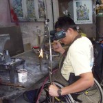 Efrain welds a custom wheelchair frame—the workshop will produce 200 wheelchairs this year
