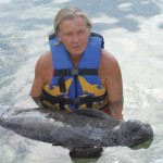 Author Janson makes friends with a young manatee