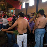 Two worshipers in San Andrés Itzapa receive a ritualistic cleansing by Thor Janson