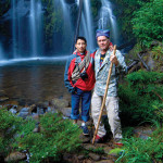 Guide Josue (left) and author Janson stop for a photo op beside some beautiful waterfalls