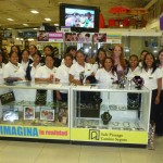 Members of Creamos behind of one of their jewelry display stands