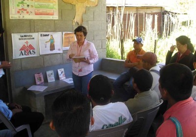 Direct Services Coordinator Patty Medina speaks to men at a community charla in Alta Verapaz.