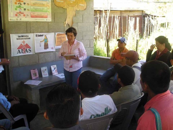 Direct Services Coordinator Patty Medina speaks to men at a community charla in Alta Verapaz.