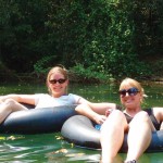 Two girls enjoying the water with their jackets