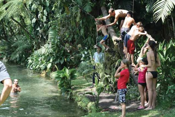 Rope swinging into the swimming pond