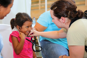 Comfort Heart: A girl listens to her own heartbeat during a medical checkup at Complejo Deportivo de Puerto Barrios. (u.s. army photo by PFC. Tomarius Roberts)
